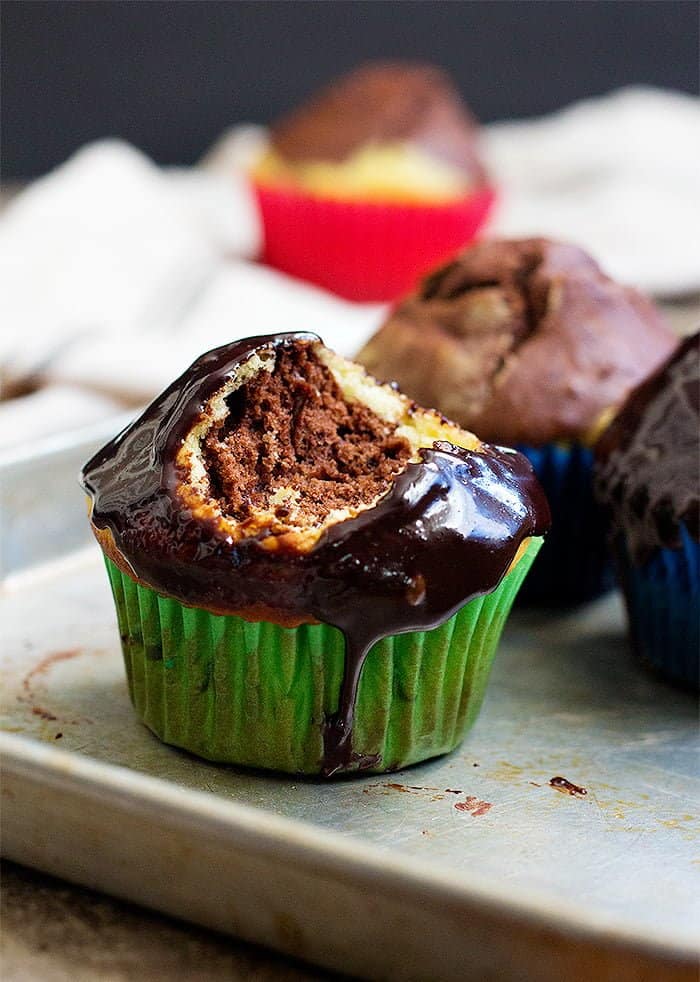 Easy Marble Cupcakes topped with chocolate glaze. 