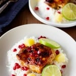 Chicken thighs baked in sweet and savory marinade and is served on white rice to make a complete meal! Pomegranate Pineapple chicken is perfect for parties or just a weekend meal!