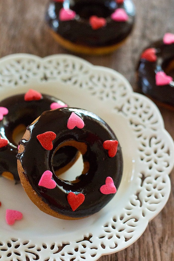 chocolate glazed donuts in white plate