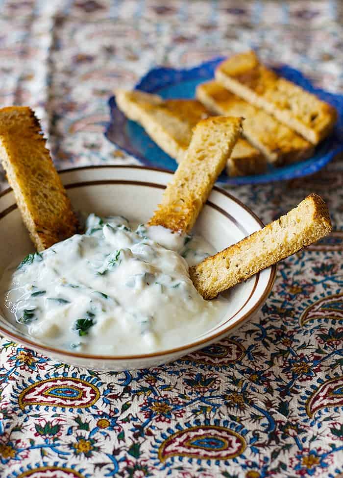 To make this dip, saute spinach with some oil and garlic. Mix with plain Greek yogurt and refrigerate for thirty minutes. 