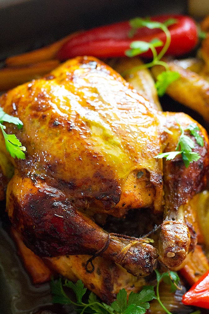 Make orange roasted chicken at home in three easy steps! Add your own homemade rub and sauce to have a perfectly golden roasted chicken that can be on the table in one hour! 