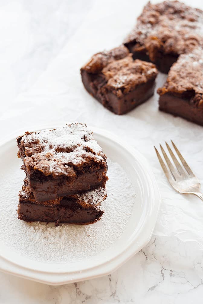 Chocolate Magic Cake - Let the cake cool completely, slice into 9 squares and dust with powdered sugar. 