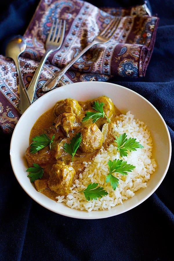 Meatballs made with turkey and spices cooked in curry and served with rice. 