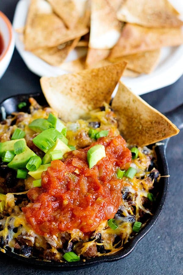 This cheesy taco dip will be the star of your parties and gathering! Serve it with homemade rosemary garlic tortilla chips for more flavor! Game days are going to be delicious! 