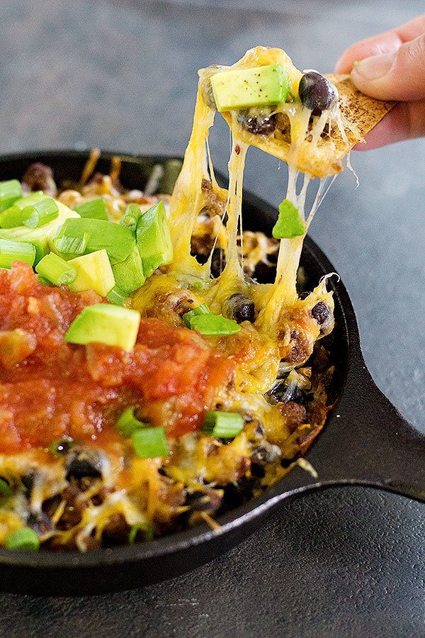 This cheesy taco dip will be the star of your parties and gathering! Serve it with homemade rosemary garlic tortilla chips for more flavor! Game days are going to be delicious! 