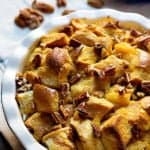 Pumpkin Pecan Bread Pudding is perfect for both dessert and breakfast. It's served with a coconut maple icing and is jam-packed with fall flavors!