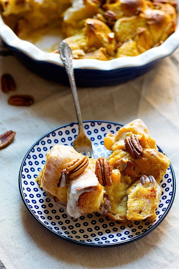 homemade bread pudding made with pumpkin and topped with coconut maple cream and pecans
