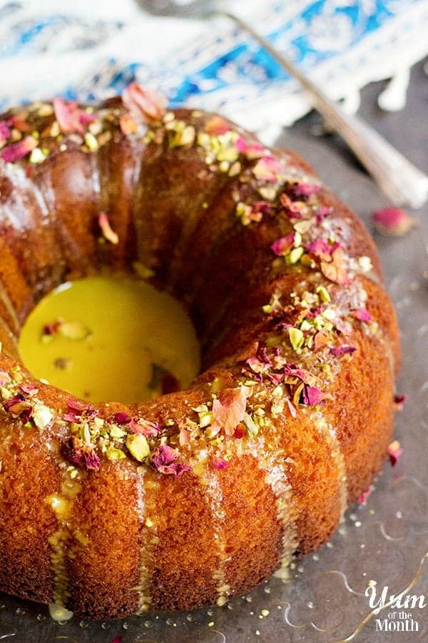 Persian bundt cake made with saffron and rose water. Topped with pistachios and rose petals.