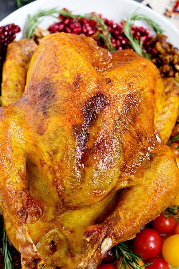 Delicious juicy roasted turkey recipe with spices and herbs that's perfect for Thanksgiving. 