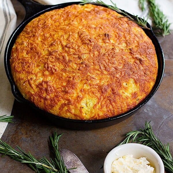 This Rosemary Cheddar Corn Bread is moist and full of delicious flavors. It's packed with aromatic rosemary baked in a cast iron skillet and has a beautiful crispy crust.