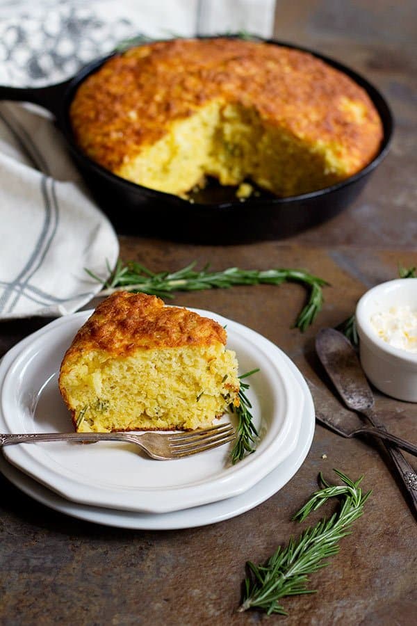 This Rosemary Cheddar Cornbread is moist and full of delicious flavors. It's packed with aromatic rosemary baked in a cast iron skillet and has a beautiful crispy crust.