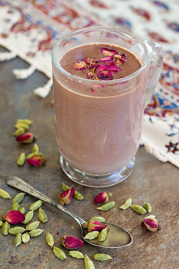 Rich Cardamom Rose Hot Chocolate is a delicious cozy drink for cold winter evenings. Quality chocolate melted in milk and infused with Middle Eastern ingredients makes for a dreamy drink.