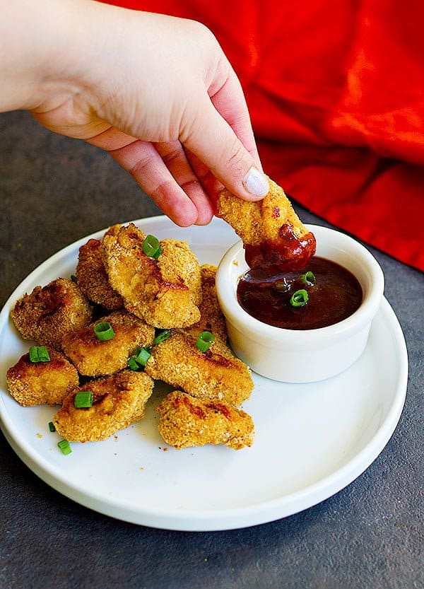 Baked Cajun Chicken Nuggets are perfect for parties or as a light meal. They are perfectly baked in the oven and by using a very simple technique, your fingers won't get all sticky!