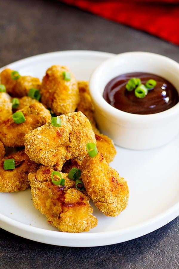 Baked Cajun Chicken Nuggets are perfect for parties or as a light meal. They are perfectly baked in the oven and by using a very simple technique, your fingers won't get all sticky!