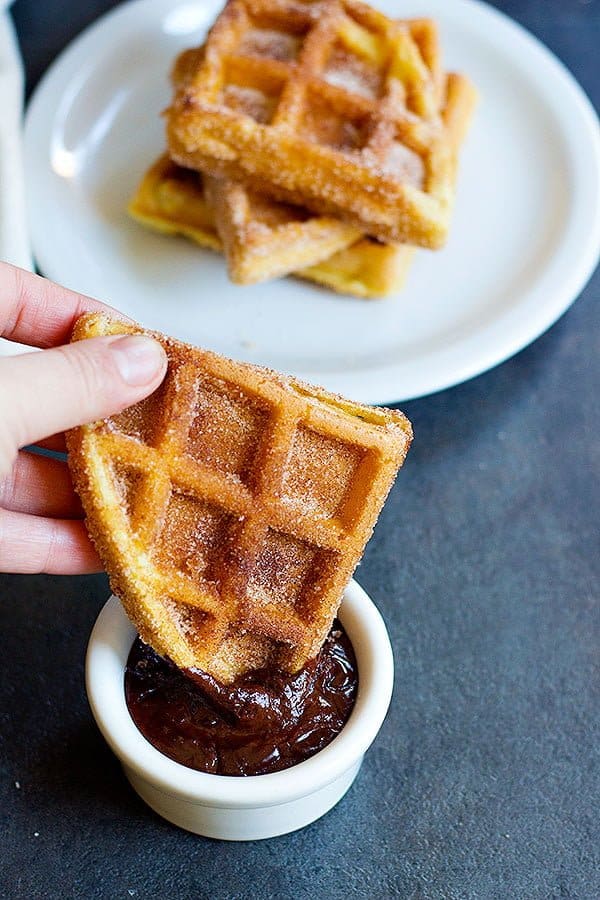 Churro Waffles are delicious fluffy waffles full of cinnamon sugar, served with some delicious chocolate!