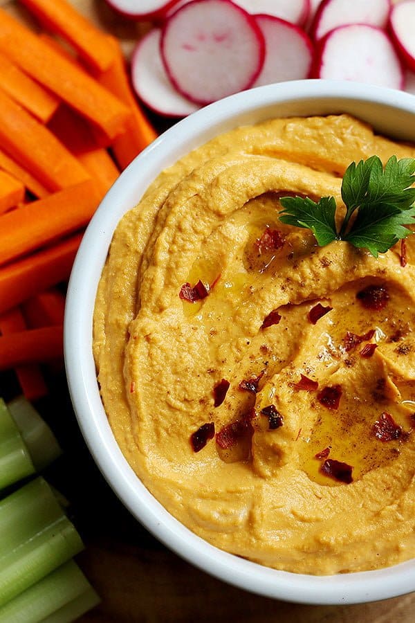 spicy hummus recipe is easy to follow and is topped with parsley, olive oil and pepper flakes. 