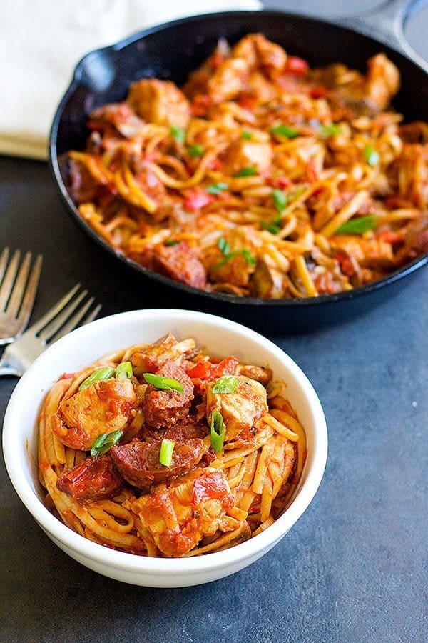 Easy Jambalaya pasta is a great dish for a family weeknight dinner. Top with green onions.