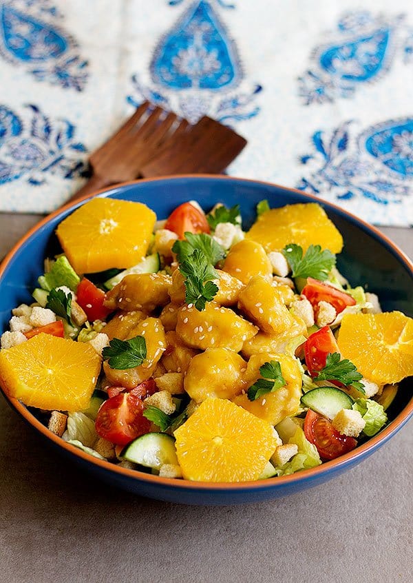 Bring excitement and flavor to ordinary dinners with this delicious orange chicken salad. Fresh salad topped with chicken smothered in lip-smacking orange sauce!