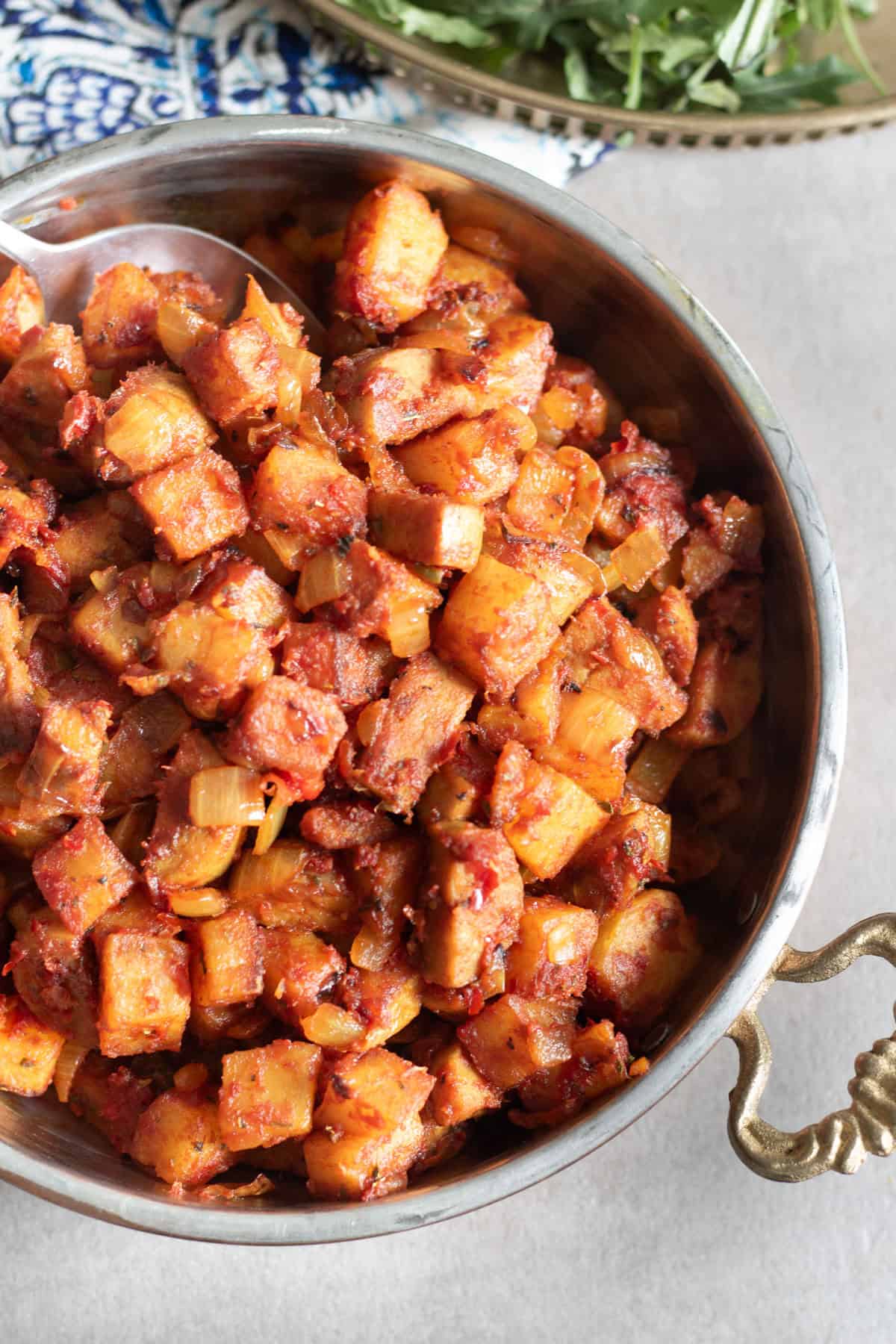 a top view of a pan of sosis bandari made with cooked sausage, potatoes, tomato paste, and spices