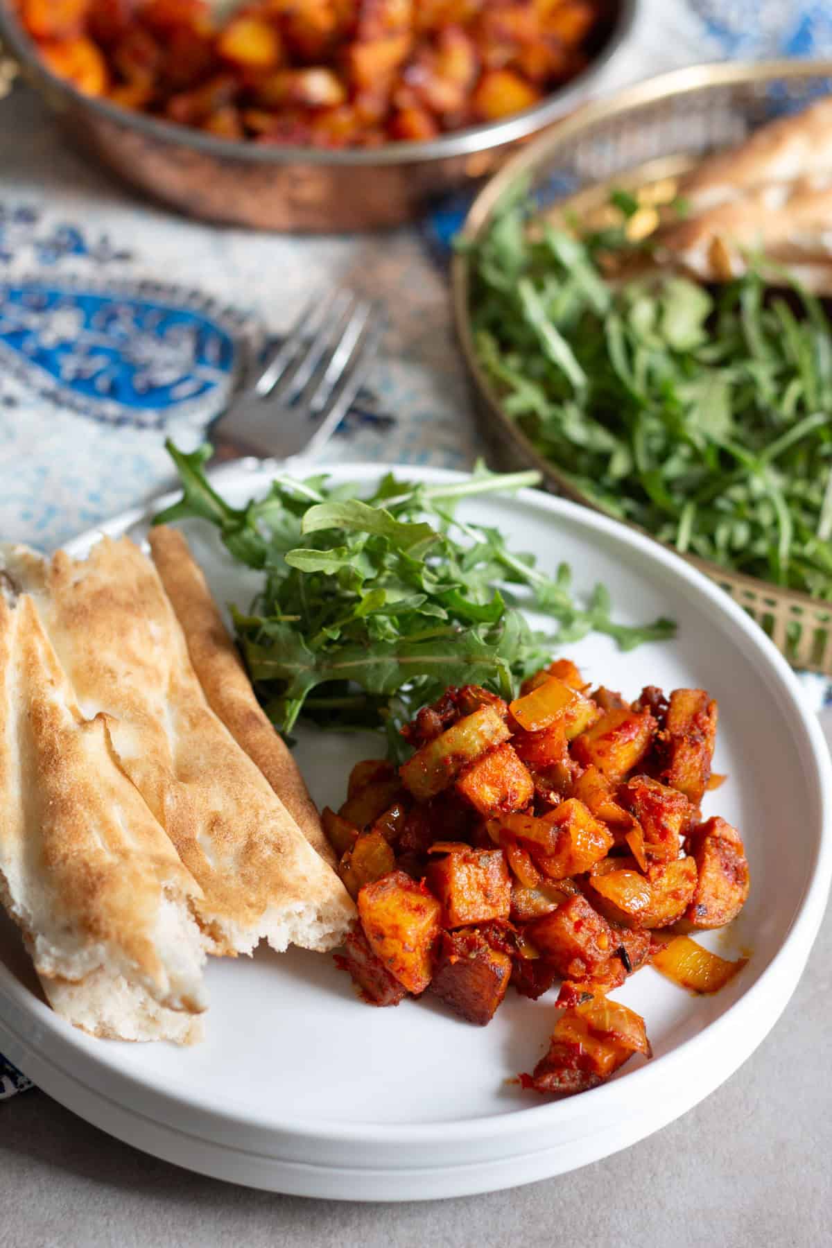 a sandwich with fresh baby arugula and Persian bread