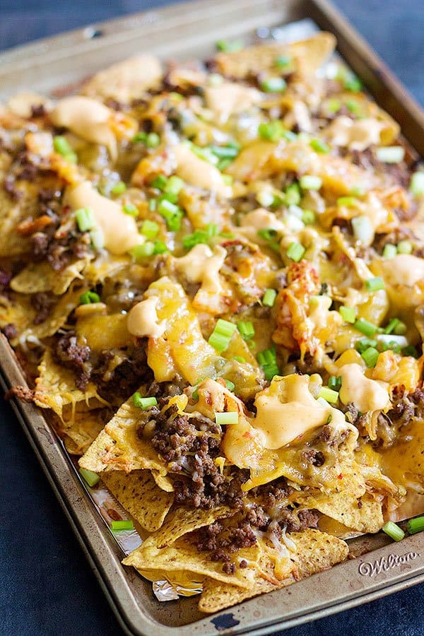 Korean Beef Nachos are a new twist on traditional nachos. The delicious Korean beef topped with Mexican blend cheese and served with sriracha mayo is an unbeatable combination!