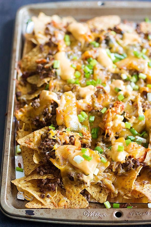 Korean Beef Nachos are a new twist on traditional nachos. The delicious Korean beef topped with Mexican blend cheese and served with sriracha mayo is an unbeatable combination!