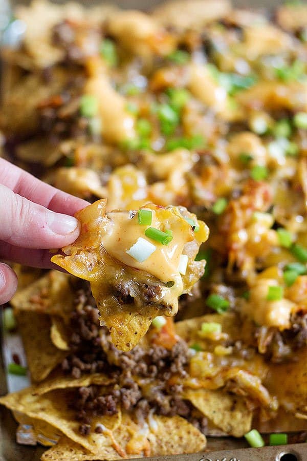 Korean Beef Nachos are a new twist on traditional nachos. The delicious Korean beef topped with Mexican blend cheese and served with sriracha mayo is an unbeatable combination!