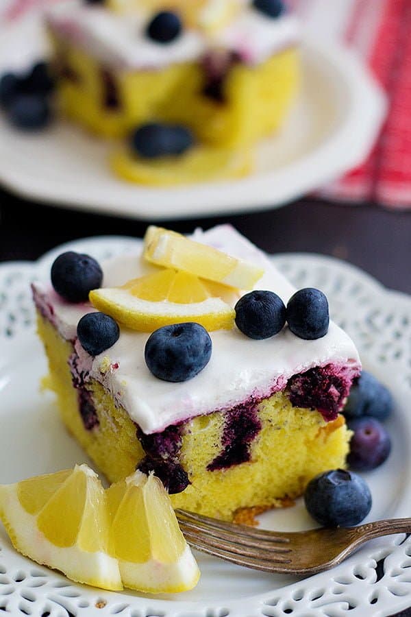 This Lemon Blueberry Poke Cake is the ultimate summer dessert. With homemade blueberry sauce and whipped cream on top, this dessert is perfect for any occasion!