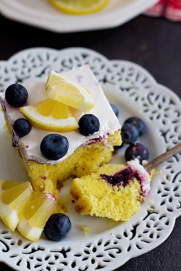 This Lemon Blueberry Poke Cake is the ultimate summer dessert. With homemade blueberry sauce and whipped cream on top, this dessert is perfect for any occasion!