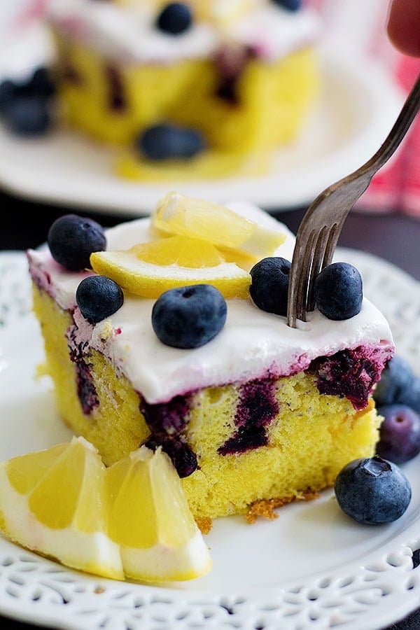 This Lemon Blueberry Poke Cake is the ultimate summer dessert. With homemade blueberry sauce and whipped cream on top, this dessert is perfect for any occasion!