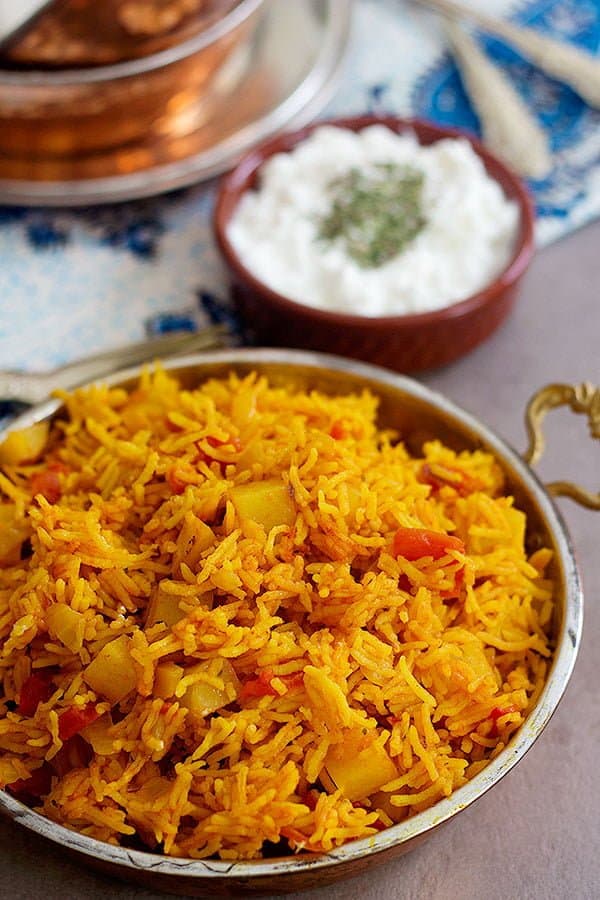 Tomato rice made Persian style and served with salad shirazi and yogurt topped with dried mint. 