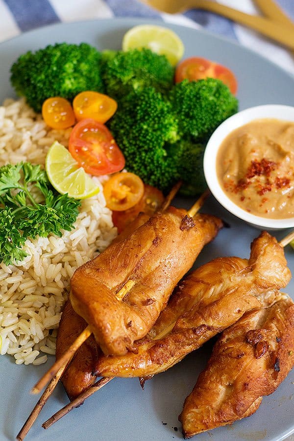 Make these delicious Thai Chicken Skewers with Spicy Peanut Sauce for an amazing family-friendly meal. The marinade is the key to these juicy and tasty skewers.