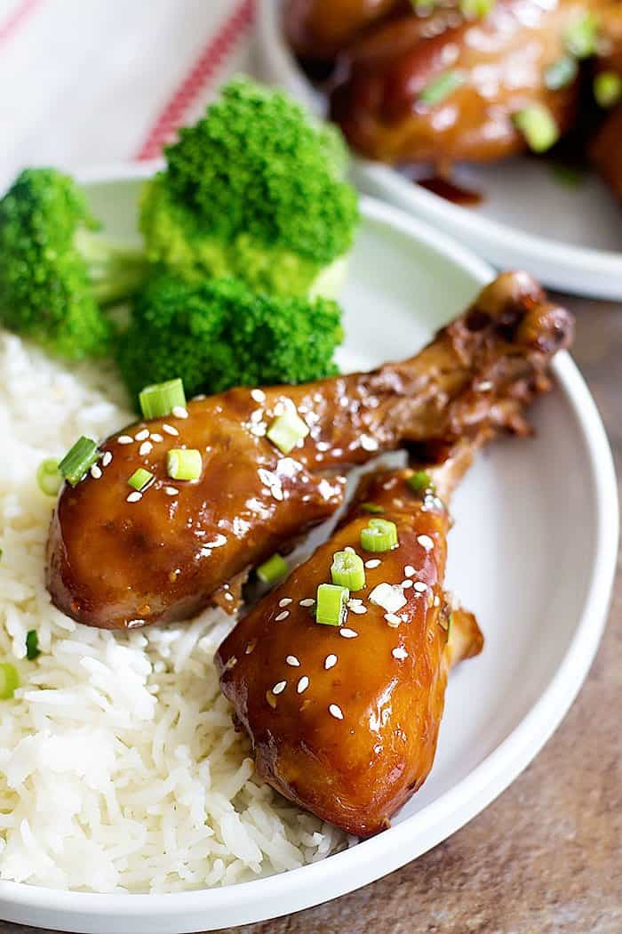 Garlic honey chicken cooked in slow cooker and topped with green onions and sesame seeds. 