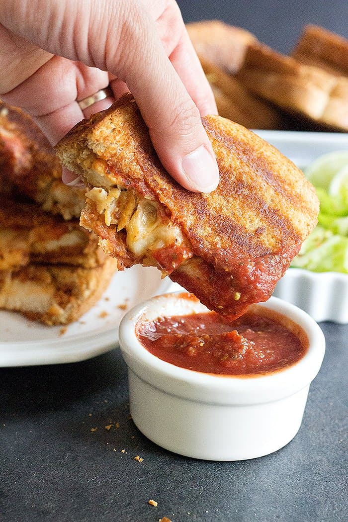 Dip grilled cheese chicken parmesan sandwich in marinara. 