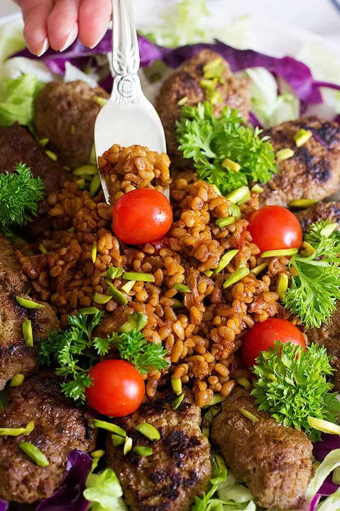 Spice up your usual meals with this Pomegranate Pistachio Koftas with Bulgur. Grilled koftas served with a delicious bulgur make the perfect meal!