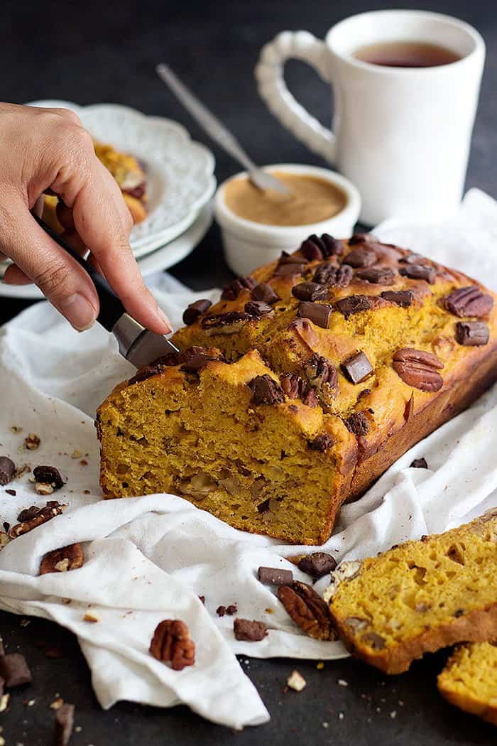 Healthy Pumpkin Banana Bread is made with Greek yogurt and is so soft. With chocolate chunks and pecans, this healthy pumpkin bread is completely irresistible!