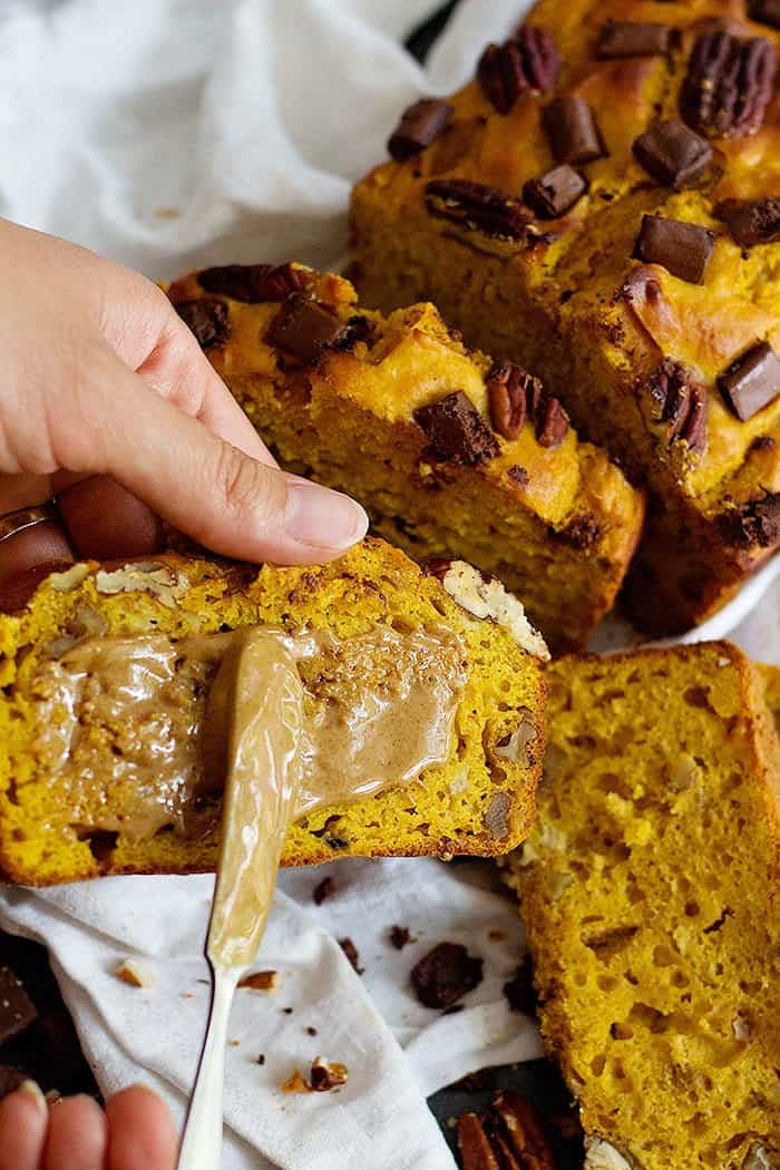 spread almond butter on healthy pumpkin banana bread for breakfast. 