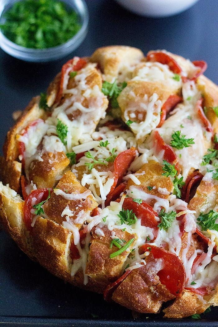 Pepperoni Pull Apart Pizza Bread is full of cheese and amazing flavors. Have your favorite pizza in a form of a pizza pull apart bread with no hassle in no time!