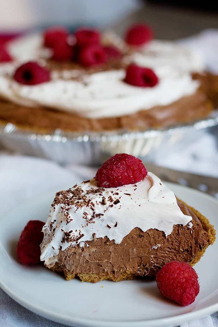 A slice of Homemade Chocolate Cream Pie with whipped cream.