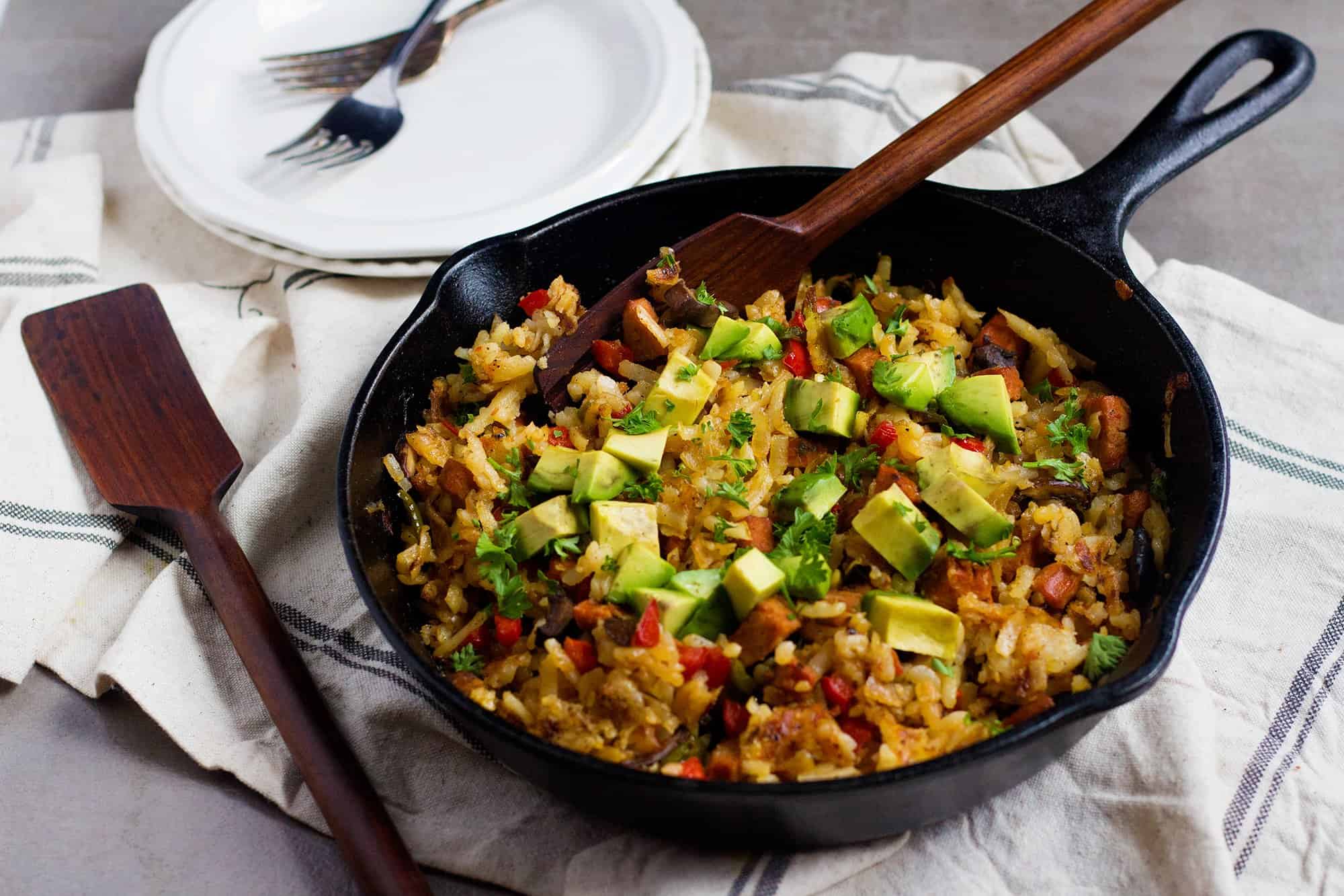 Skillet Hash Browns topped with avocados for breakfast or brunch. 