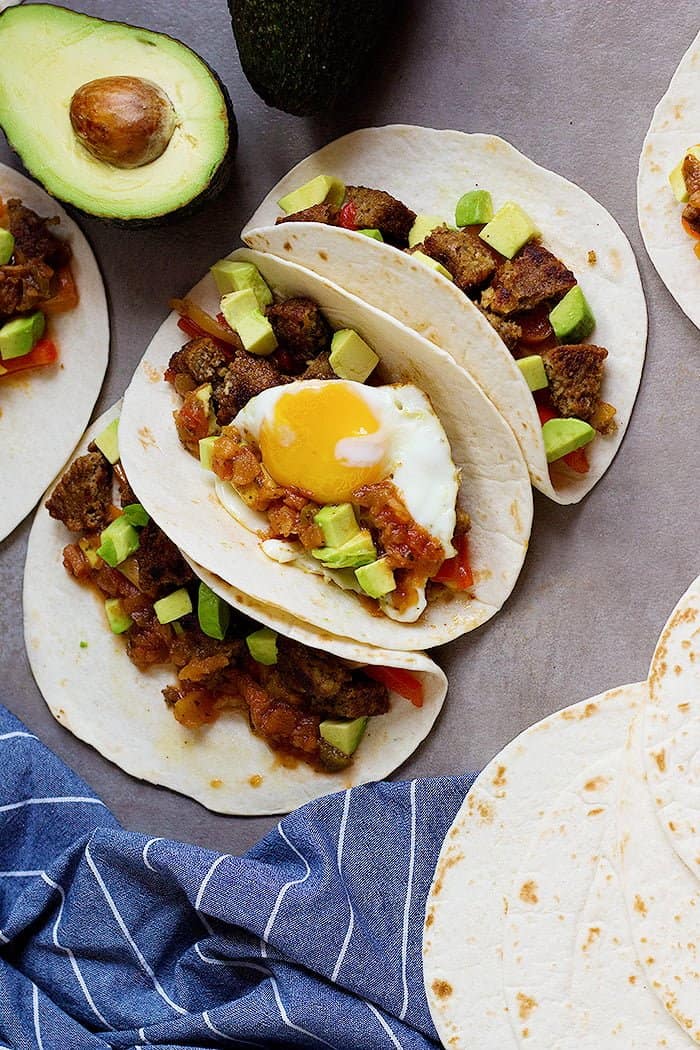 This Breakfast Tacos Recipe is an easy one that's perfect for any day of the week. Colorful veggies with avocado, salsa and a sunny side up egg make the best breakfast that everyone loves.