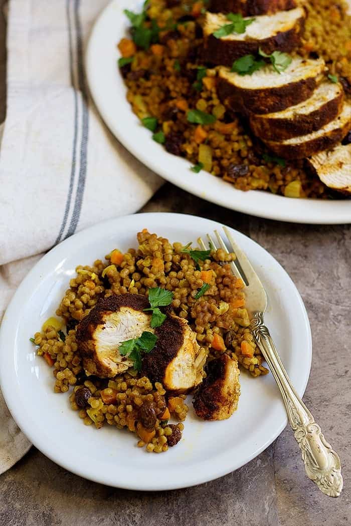 Moroccan chicken recipe with couscous served on a plate. 