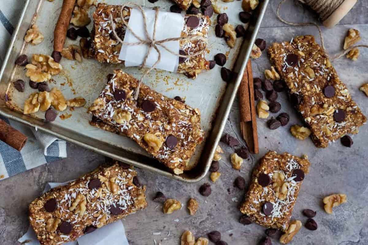 chewy granola bars wrapped in parchment paper and served on a tray