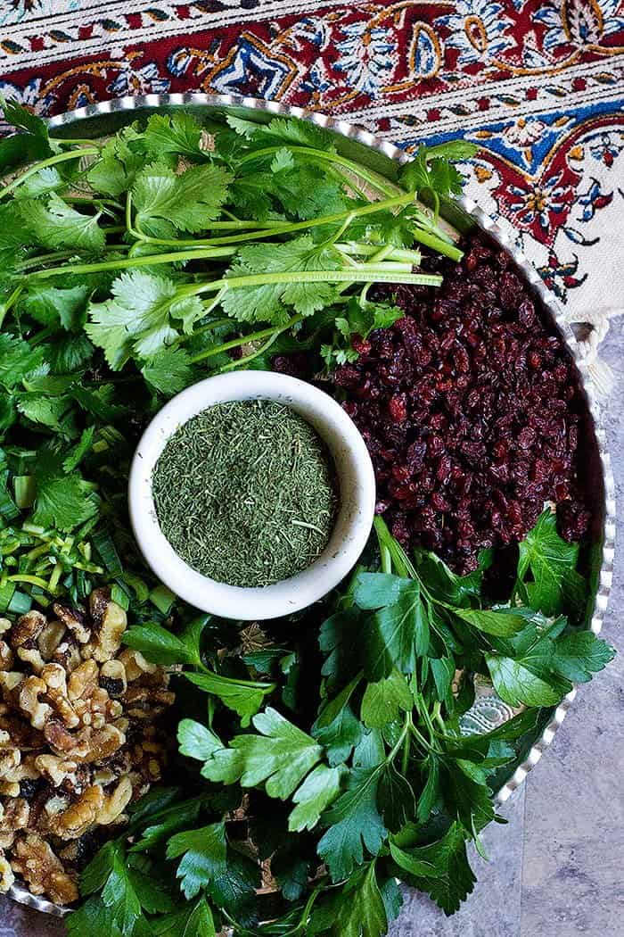 Ingredients for Kuku Sabzi are Parsley, leeks, cilantro, dill, walnuts and barberries. 