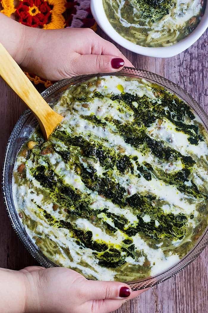 Ash Reshteh also known as Ash e Reshteh or Persian Noodle Soup is served with Kashk and seared dried mint and turmeric.