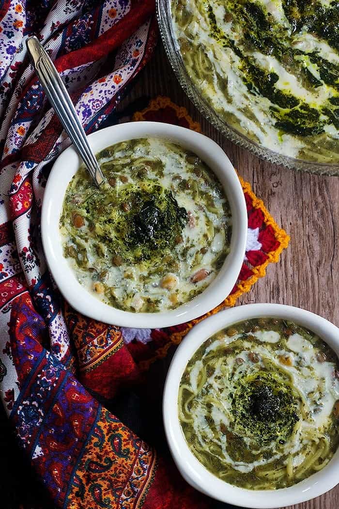 Ash Reshteh (Persian noodle soup) made using fresh herbs and legumes. 