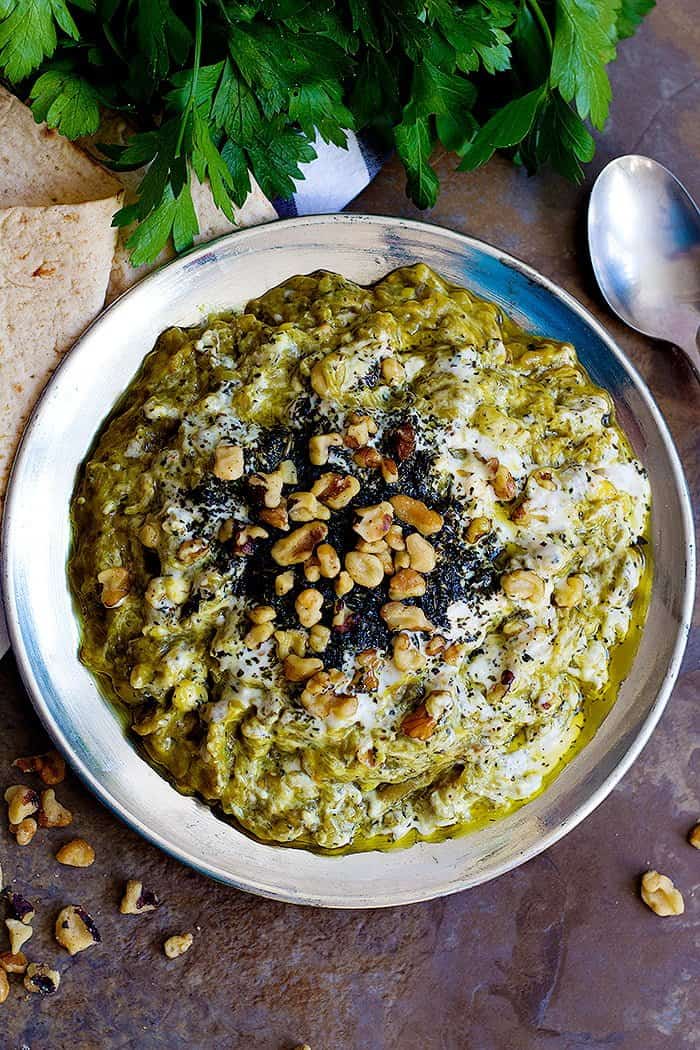 The toppings for this Persian eggplant dip are kashk, sauteed mint and walnuts. 