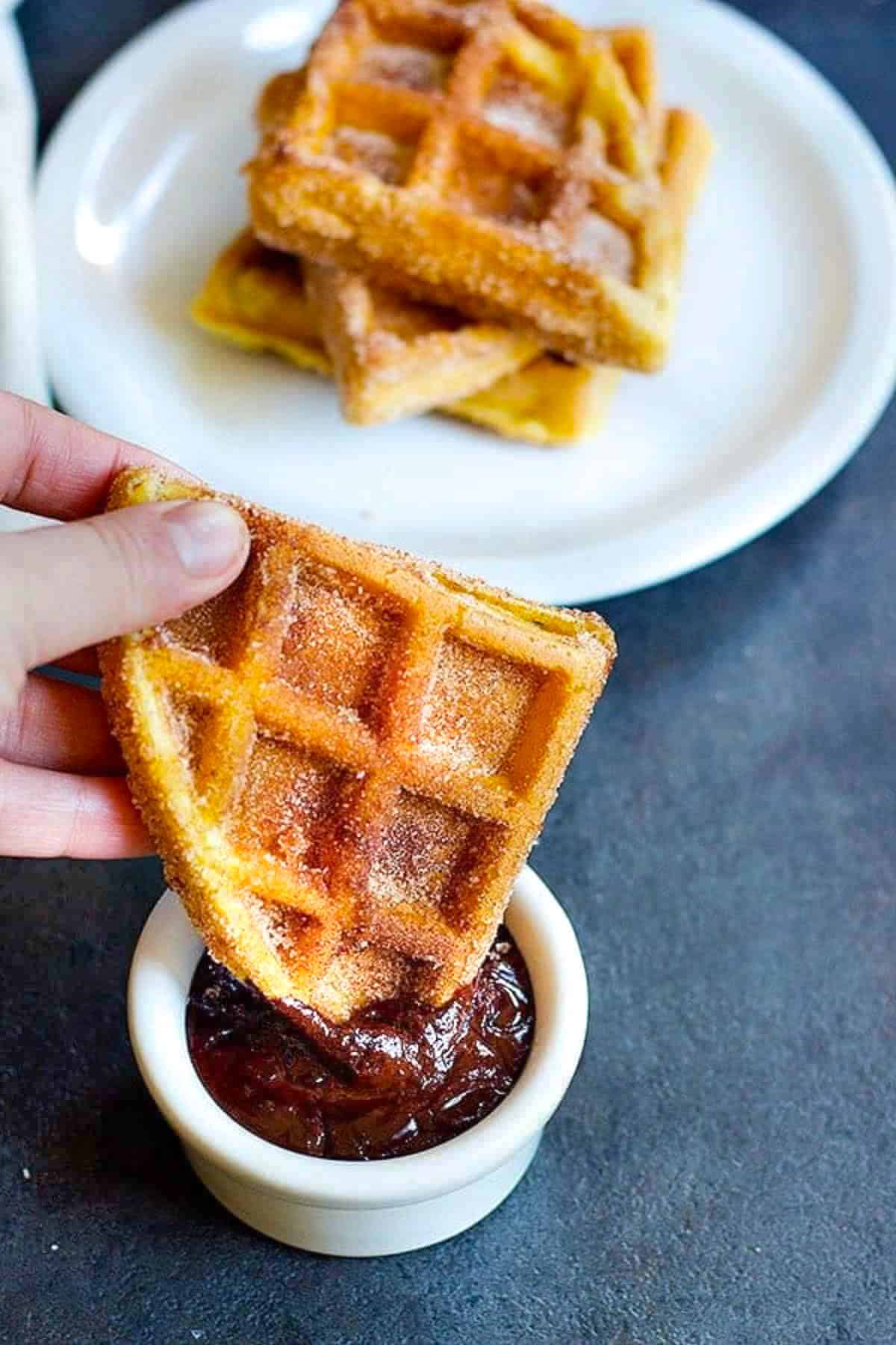 Churro Waffles are delicious fluffy waffles full of cinnamon sugar, served with some delicious chocolate!