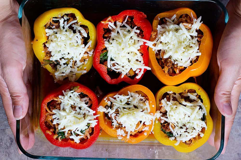 Baked Stuffed Peppers stuffed bell peppers with rice topped with shredded mozzarella cheese and bake in the oven.