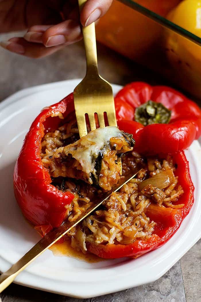 Stuffed sweet peppers are made with rice, ground beef, mushrooms and spinach. 